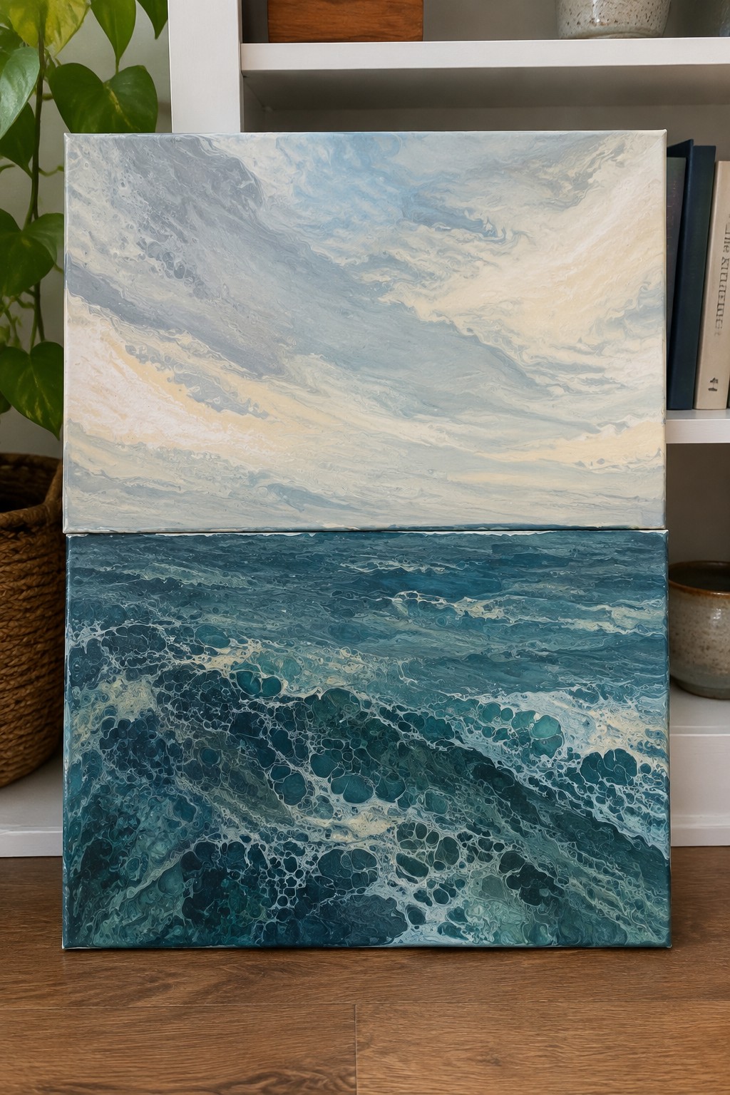 Two abstract paintings stacked as sky above teal ocean waves with foam.