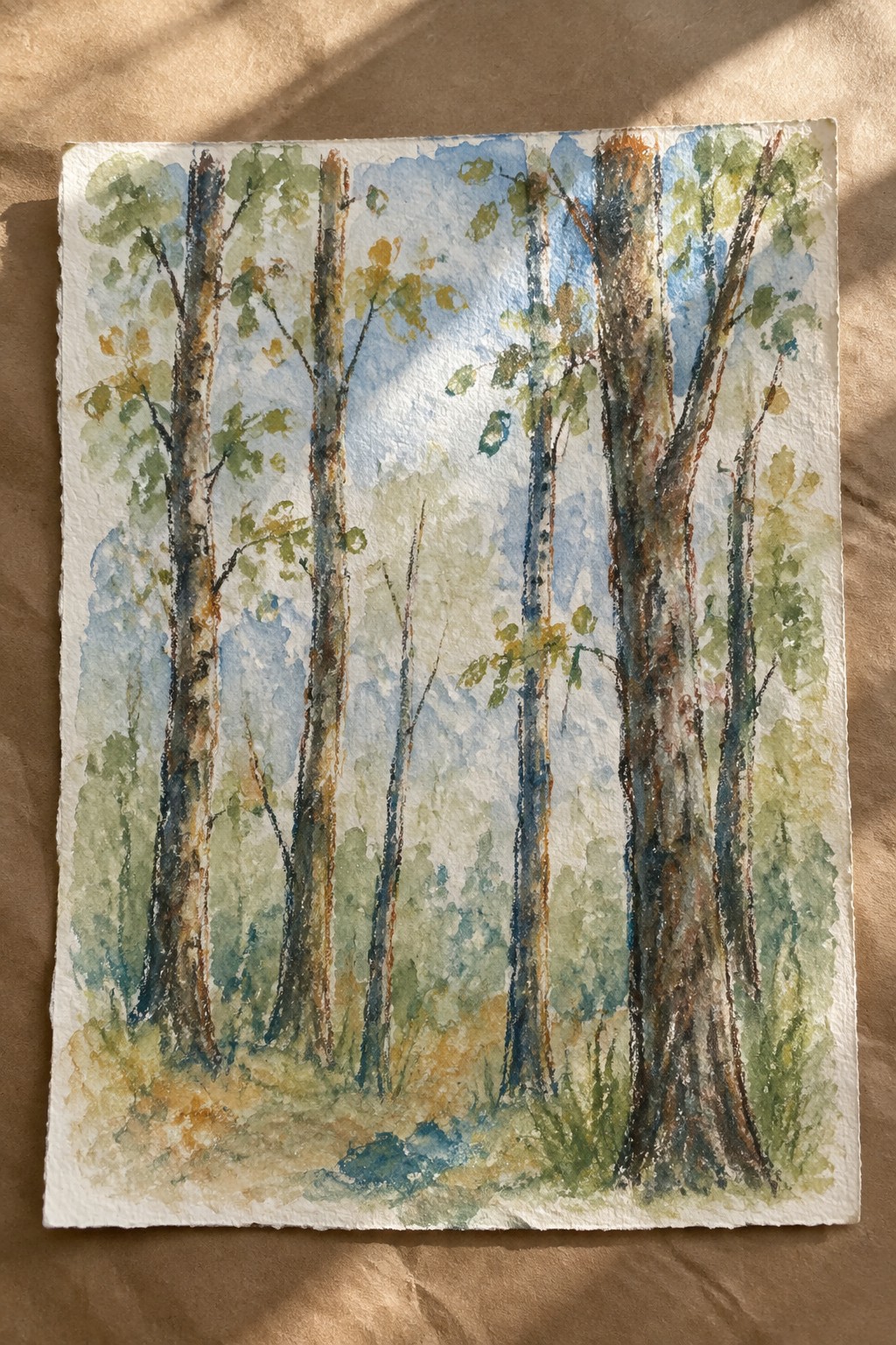 Watercolor painting of tall trees with green leaves under blue sky in forest