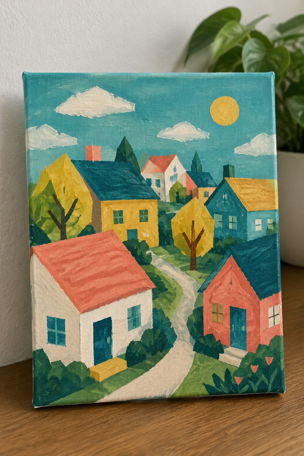 Colorful folk-art painting of village houses, trees, winding path under sunny blue sky