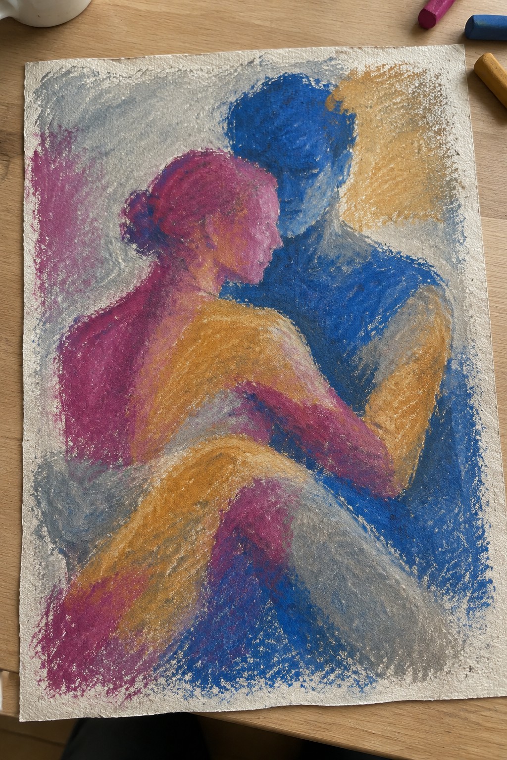 Pastel drawing of pink-haired woman and blue man embracing, with yellow and gray tones