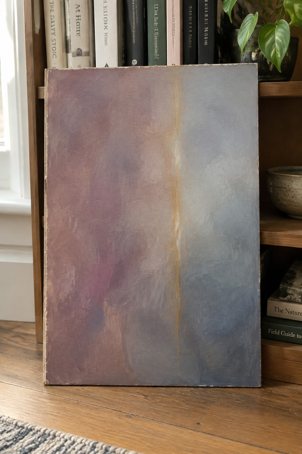 Abstract painting with purple-blue gradient and central streak leaning on bookshelf