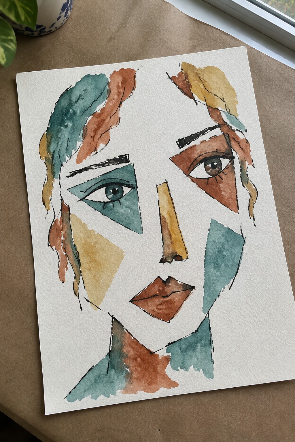Abstract watercolor portrait of a face in fragmented teal, brown, and ochre shapes.