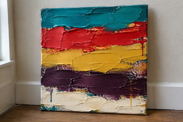 Abstract painting with thick horizontal layers of teal red yellow purple and white on canvas