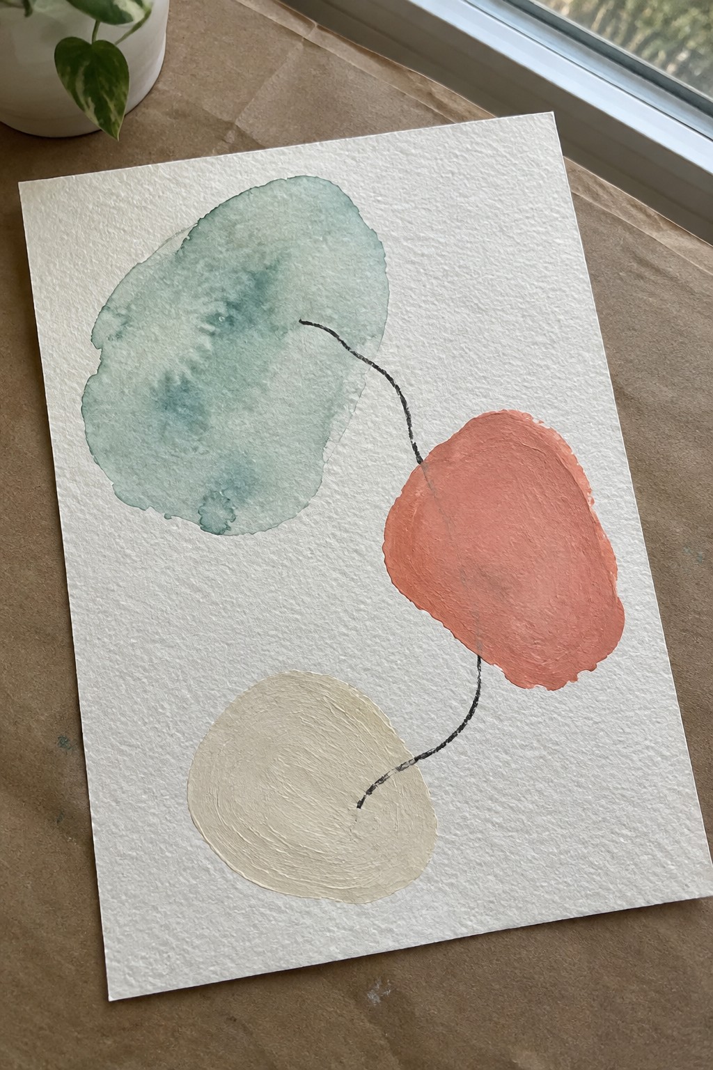 Abstract watercolor with teal circle, coral shape, and beige form linked by black lines
