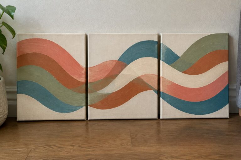 Three abstract wave paintings in coral, teal and sage on canvases