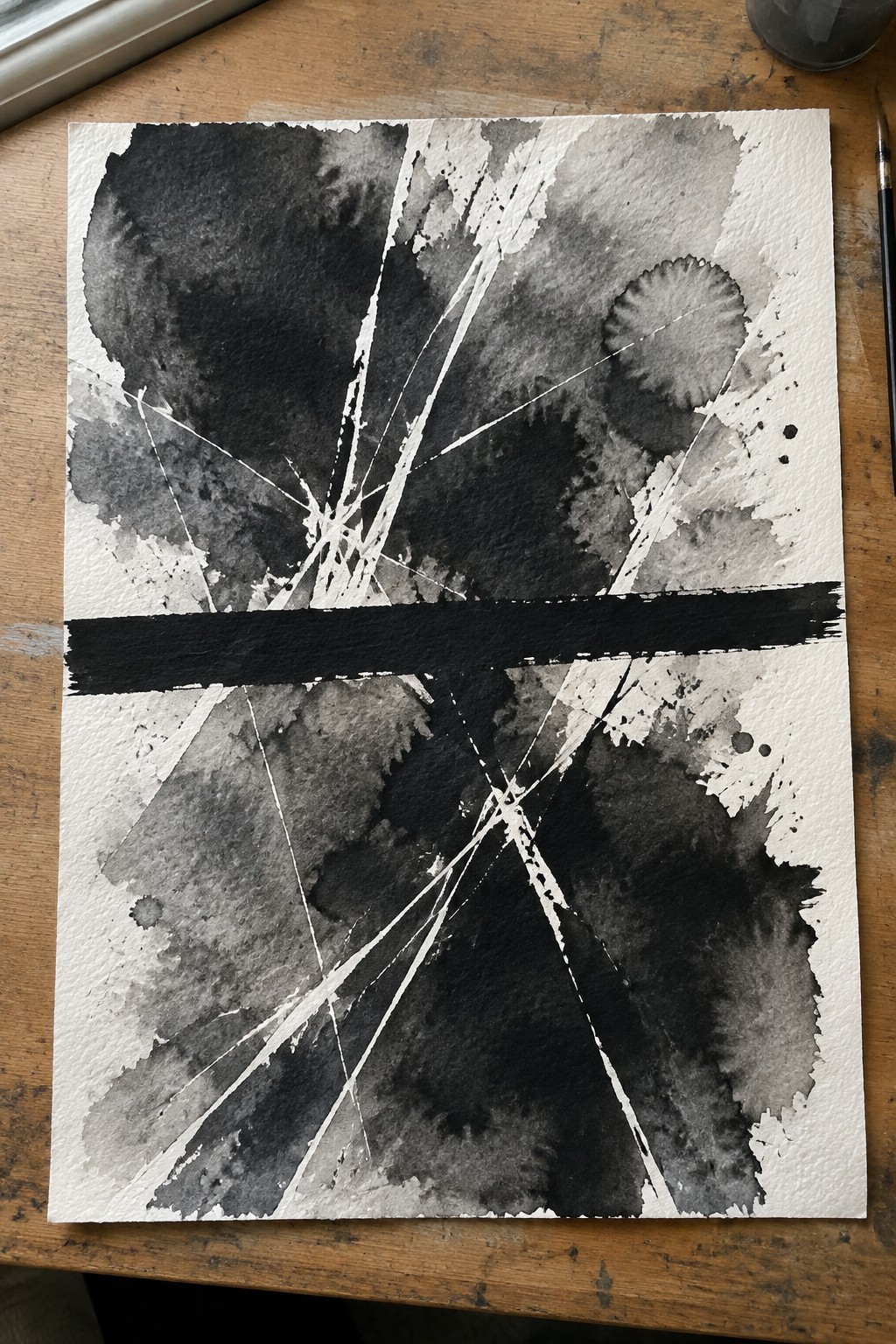 Abstract black-and-white watercolor with dark washes, white scratches, and bold horizontal stroke on paper.