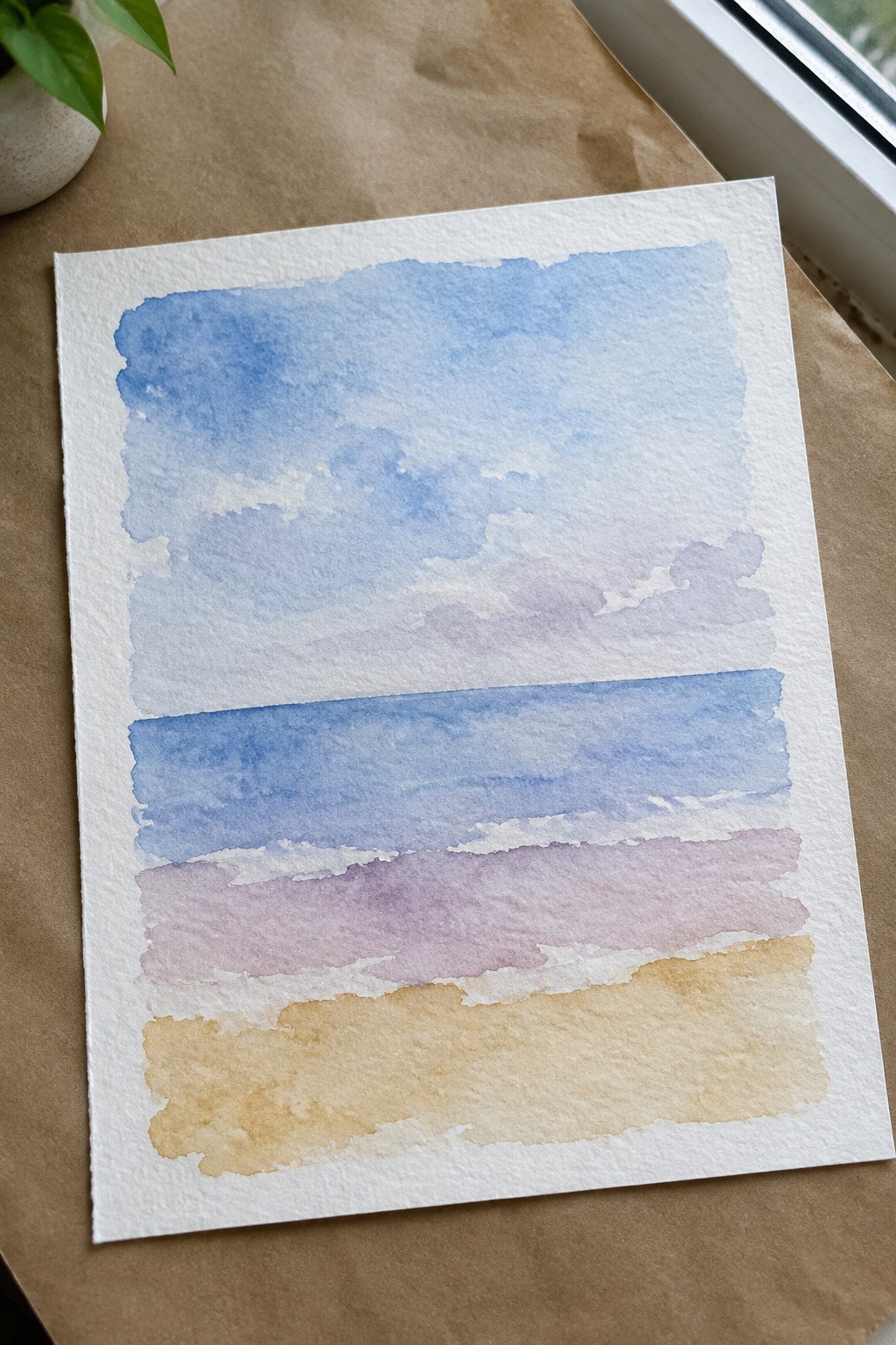 Watercolor painting with soft blue, purple, and yellow horizontal washes on white paper
