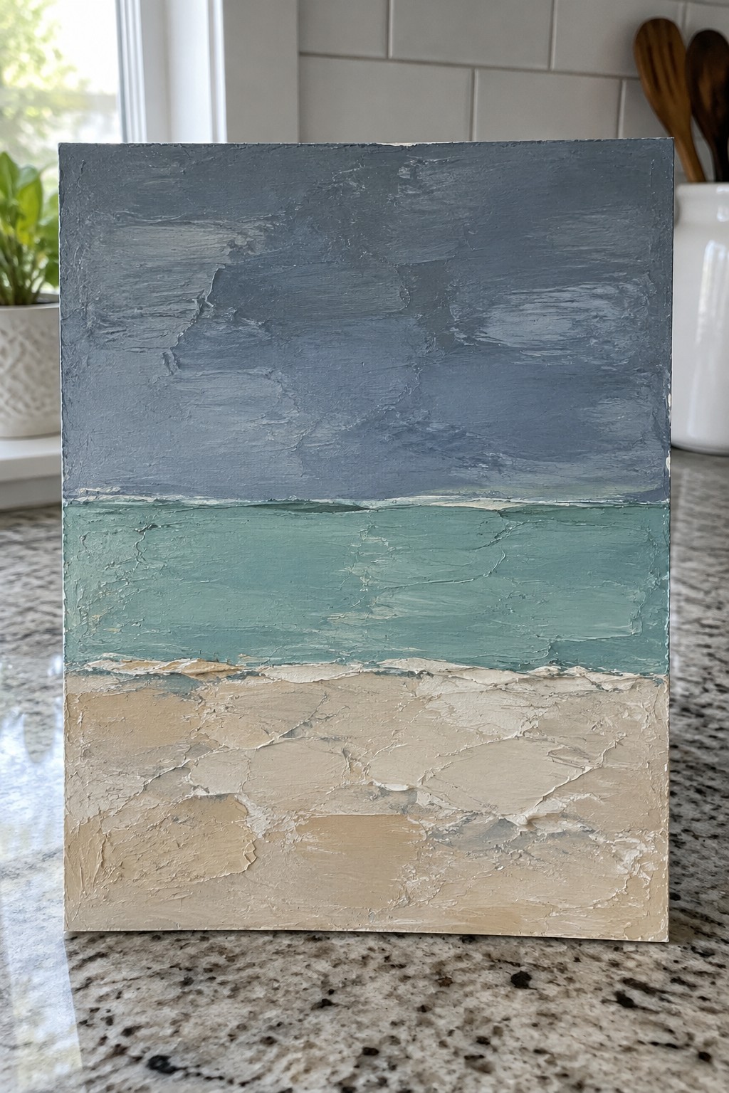 Textured abstract painting with blue top, teal middle, and beige bottom layers.