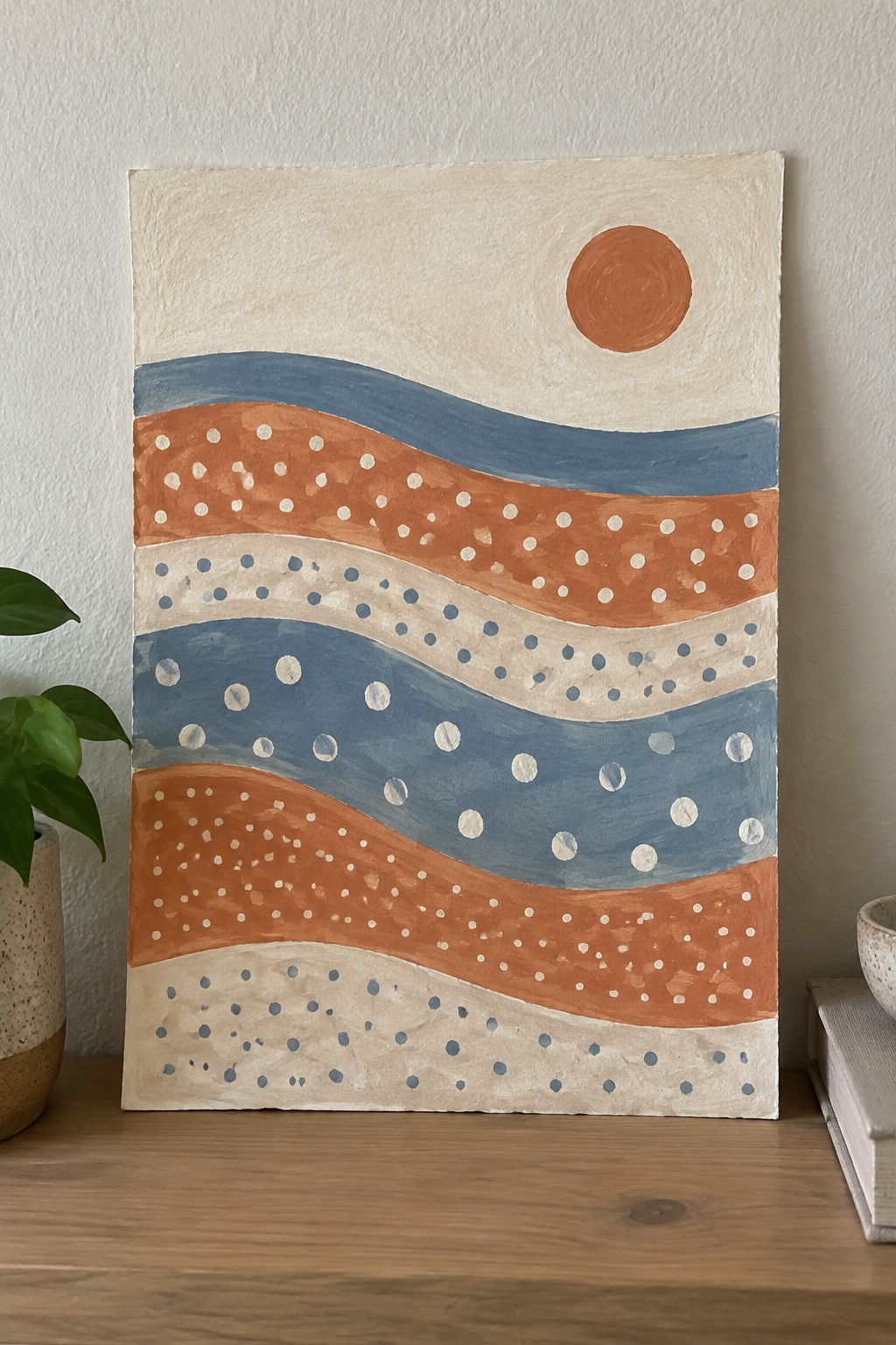Abstract painting with wavy orange, blue, and beige stripes, dotted patterns, and orange sun