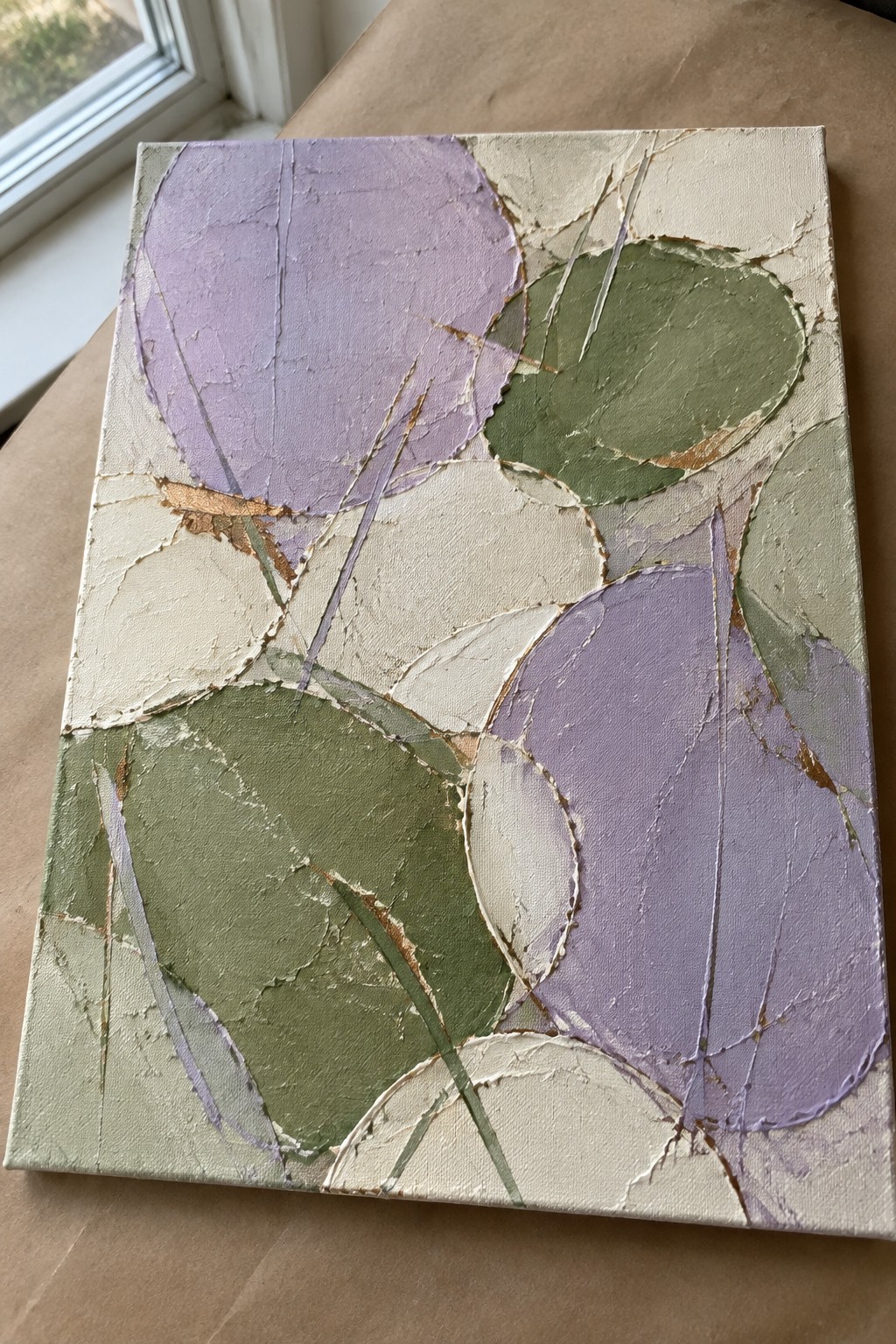 Abstract painting on canvas with overlapping purple, green, and cream cracked shapes.