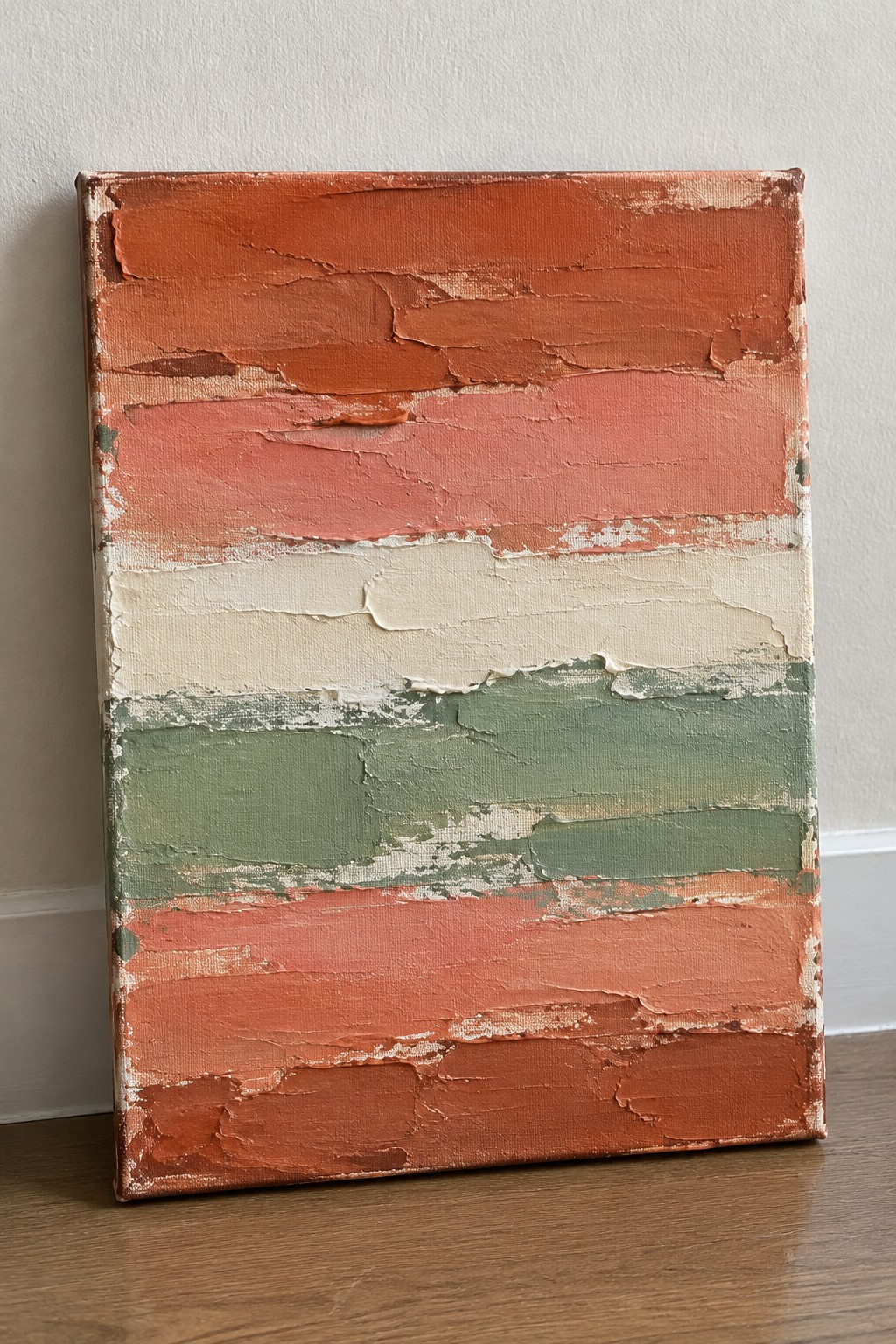 Abstract painting with thick horizontal layers of orange, red, pink, cream, and green paint on canvas.