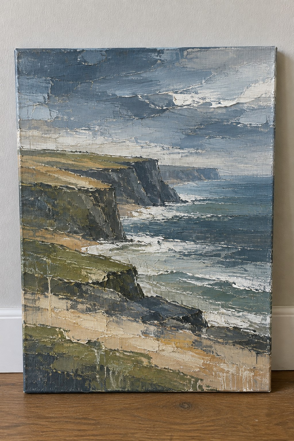 Impasto painting of rugged cliffs, crashing waves, and stormy blue sea.
