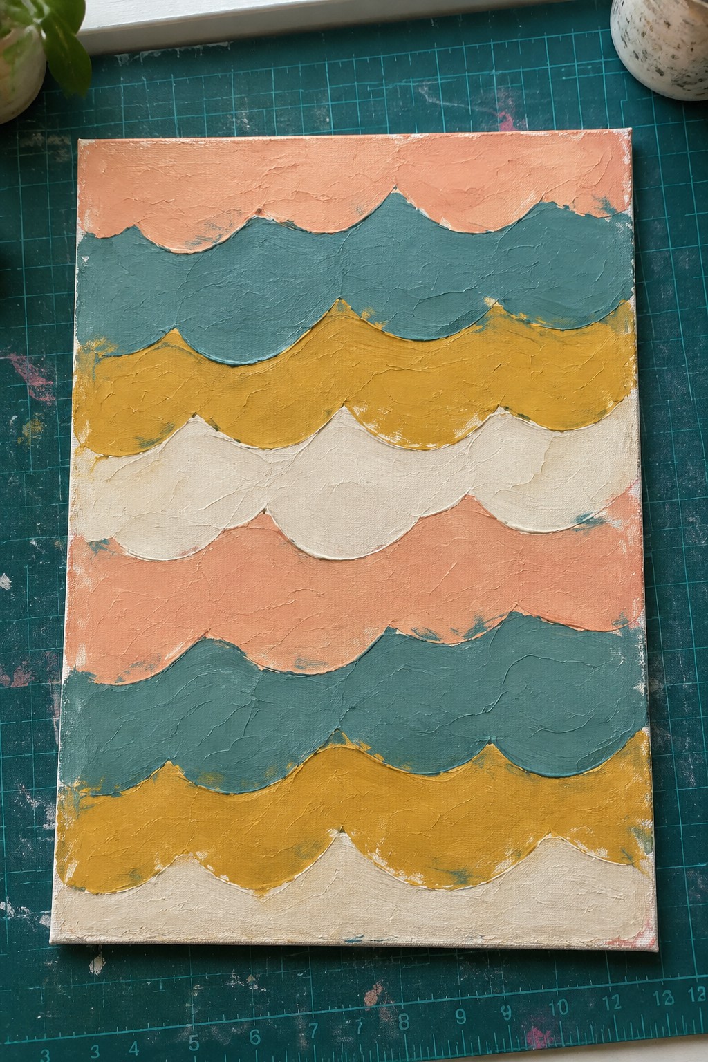 Textured canvas with scalloped waves in coral, teal, mustard, and cream paint