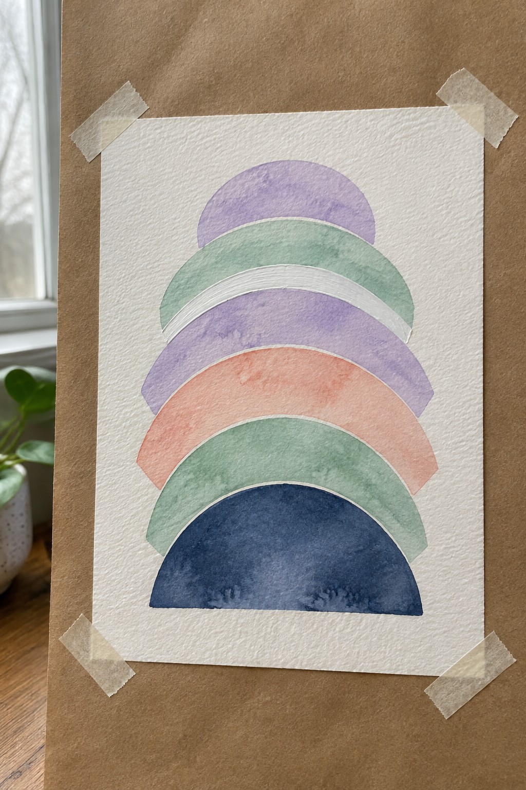 Watercolor rainbow with purple green lavender coral and navy semicircular arches on white paper