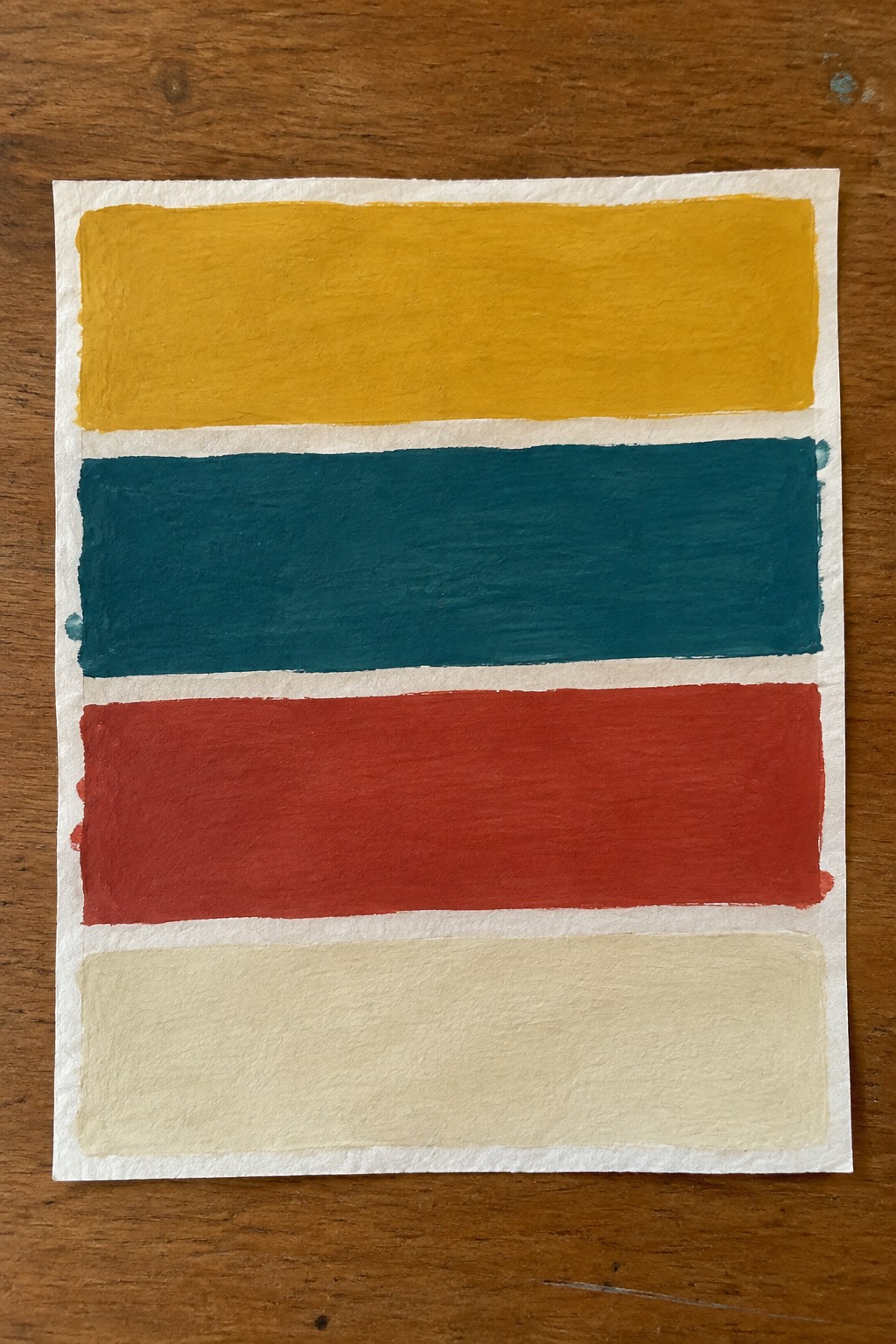 Four horizontal stripes in yellow, teal, red, and beige on white paper