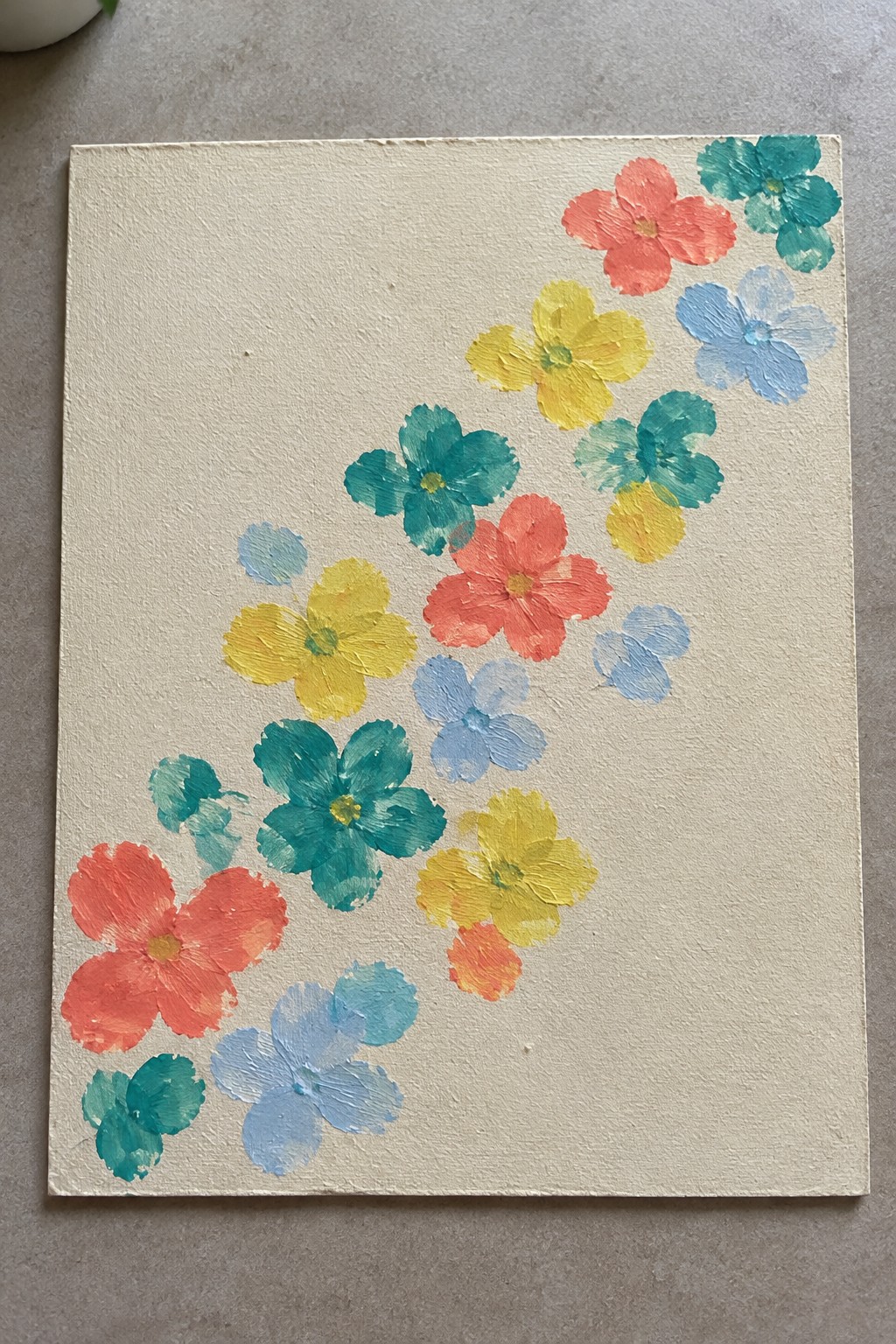 Diagonal arrangement of red, yellow, teal, and blue painted flowers on a cream canvas.