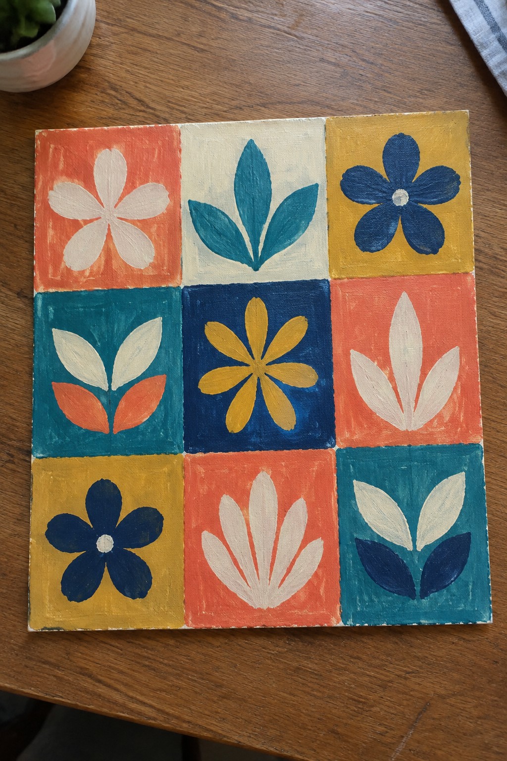 Colorful 3x3 grid of hand-painted floral motifs in bold bright hues on canvas.