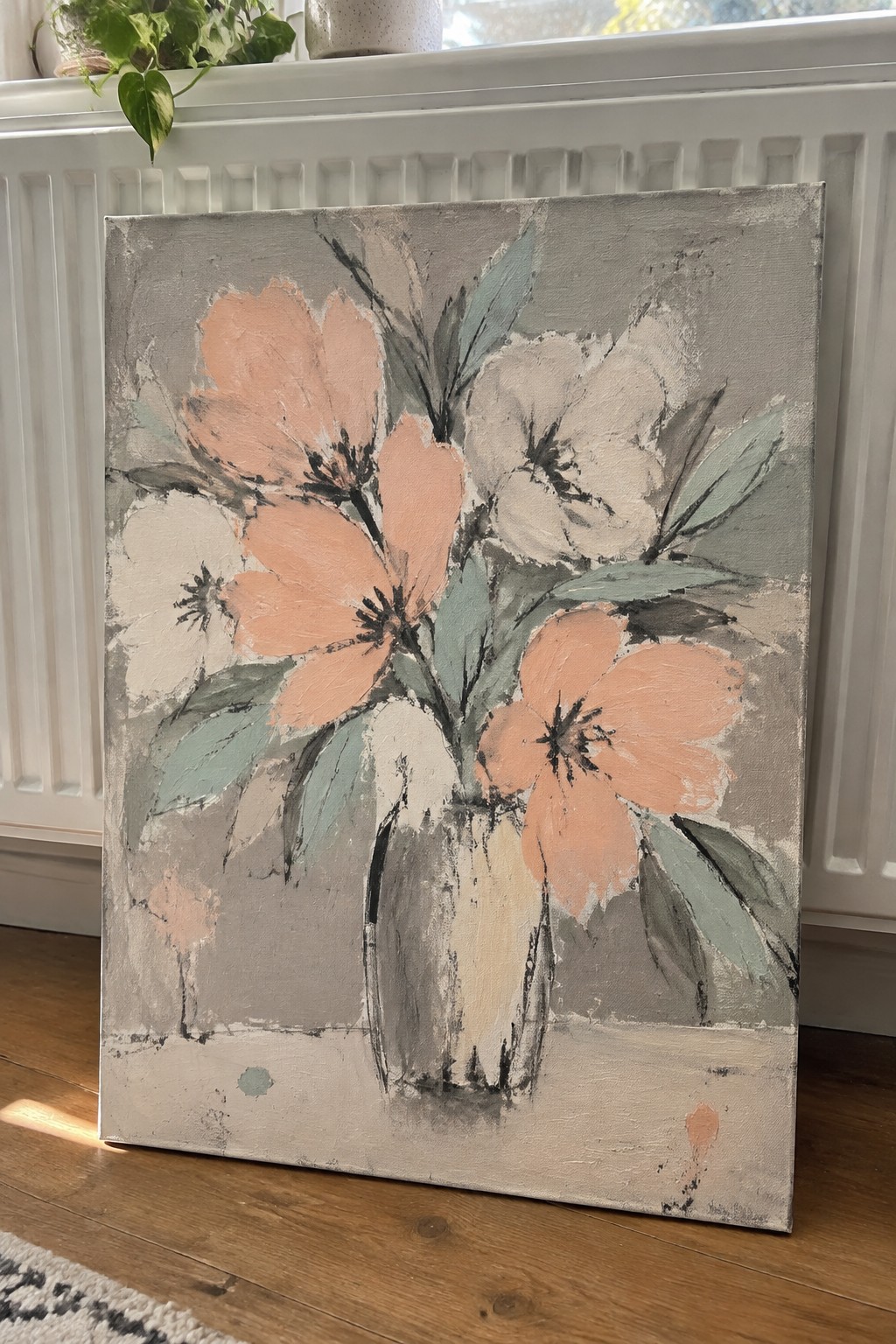 Abstract painting of peach and white flowers with green leaves in a gray vase