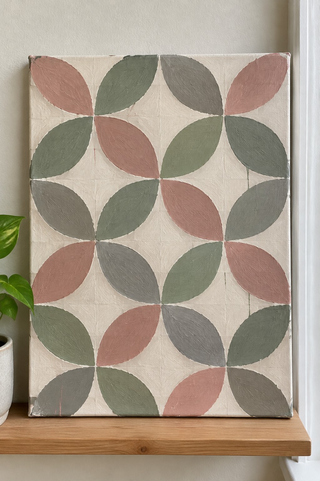 Canvas with geometric pattern of overlapping ovals in muted pink, green, and gray