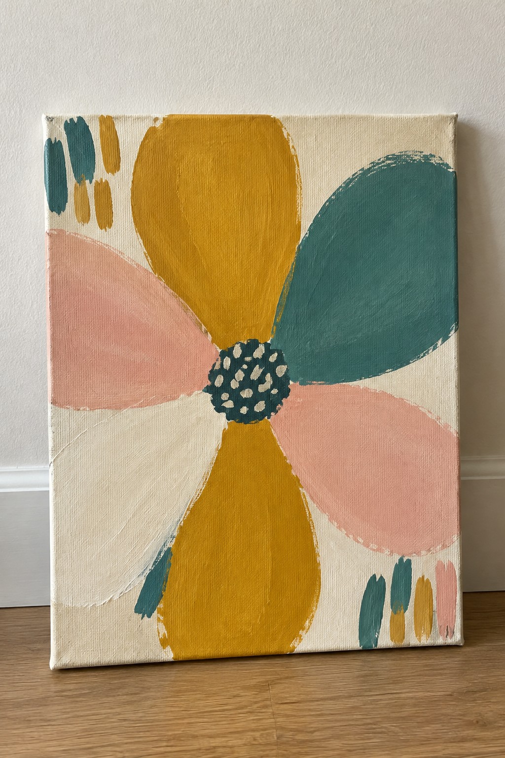 Abstract flower painting with yellow, teal, pink petals and dotted center on canvas