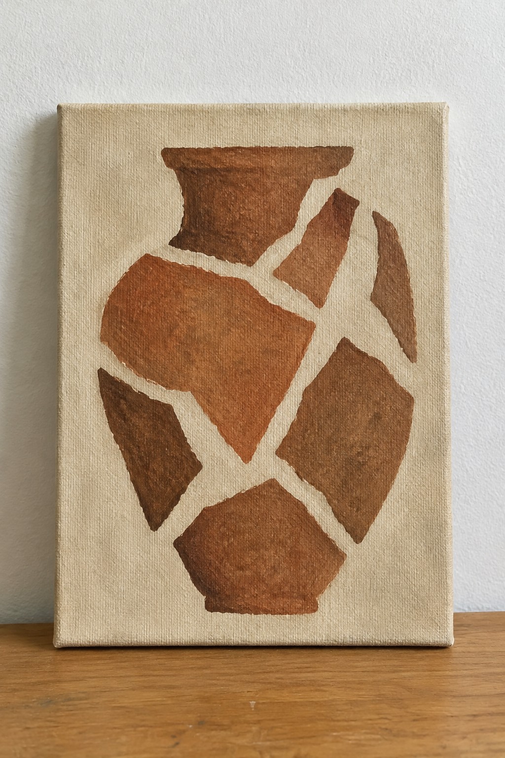 Abstract painting of fragmented brown vase on beige canvas over wooden surface