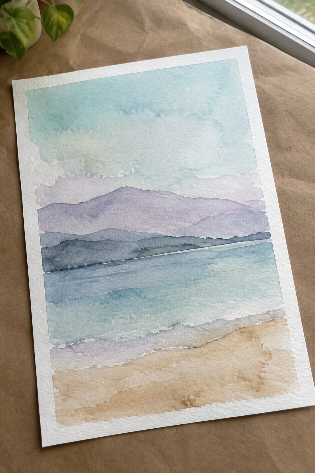 Watercolor seascape with layered purple hills, turquoise water, and sandy beige shore