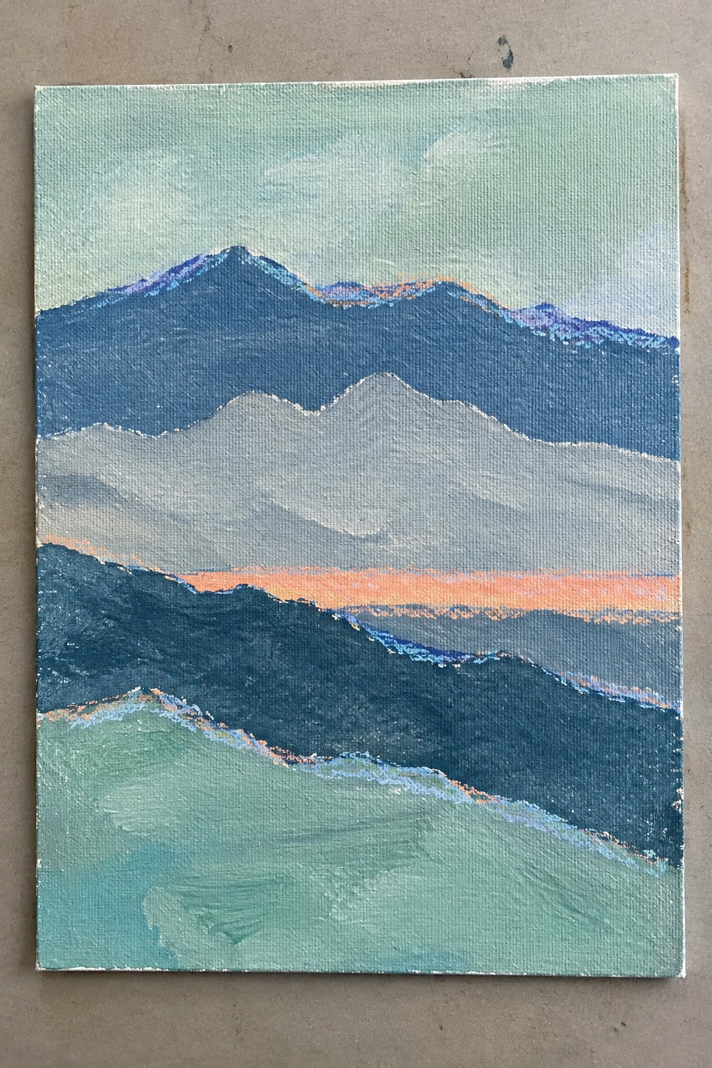 Layered blue-green mountains with orange horizon accents on textured canvas