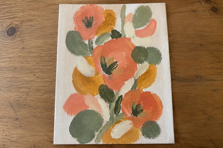 Abstract floral painting with coral orange and yellow blooms plus green leaves on canvas