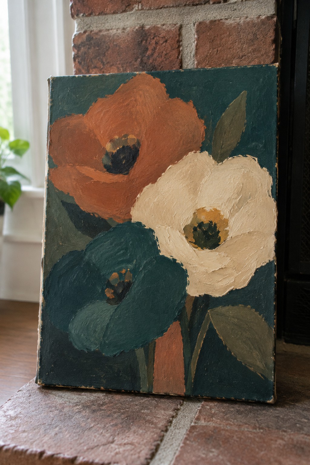 Bold floral painting with orange, white, and teal blooms on brick hearth.
