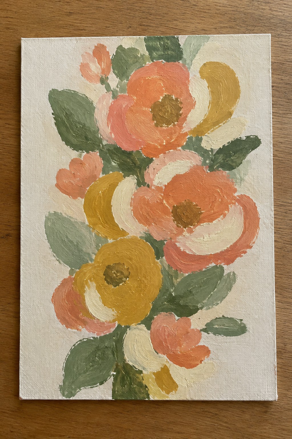 Abstract floral painting with coral orange and yellow blooms plus green leaves on canvas